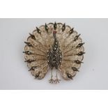 A marcasite and paste silver filigree peacock brooch, marcasite set body and tail feather tips, pink