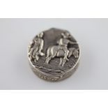 An Edwardian silver circular patch box, repousse rustic country scene to lid of rider on horse