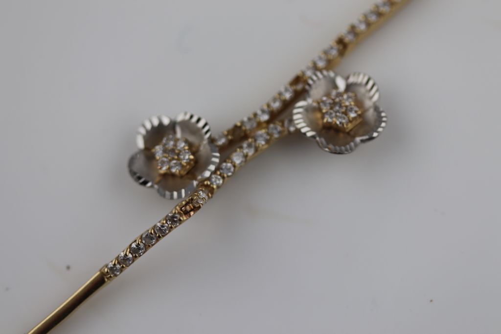 A white stone 14ct yellow and white gold bracelet, floral design, tongue and box snap clasp, - Image 4 of 5