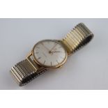 A Gents Cyma Cymaflex 9ct yellow gold cased wristwatch, cream dial, gilt baton numerals and pencil