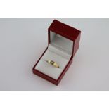 A diamond solitaire 18ct yellow gold ring, the claw set round brilliant cut diamond measuring