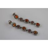 A pair of fire opal and red stone silver drop stud earrings, comprising five cluster style links,