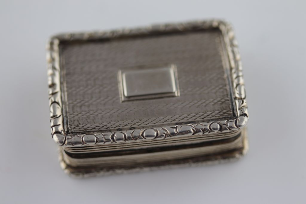 A William IV silver vinaigrette, the lid engine turned with blank cartouche and foliate border