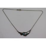 A Scandinavian style turquoise and silver pendant necklace, stylised bird and leaf design,