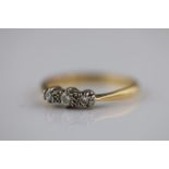 A diamond three stone 18ct yellow gold ring, bead set round brilliant diamonds, total diamond weight