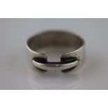 Ed Wiener (American, 1918-1991): a silver Ed Wiener Gents modernist ring, the wide band punctuated