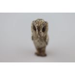 An novelty silver barn owl figurine, textured feathers, standing position, red paste eyes, London