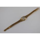 A ladies 18ct yellow gold square cased Longines wristwatch, cream dial with gold baton and Arabic