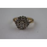 ***AMENDED DESCRIPTION*** A CZ 18ct yellow gold and white gold set seven stone flower head cluster