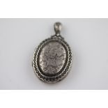 A Victorian silver locket, Birmingham 1881, makers initials E.R, the centre panel with engraved