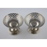 A matched pair of Walker and Hall silver pedestal bon bon dishes, pierced circular basket raised