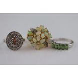 An opal and diamond fancy flower head cluster silver gilt ring, the oval, round and pear shaped