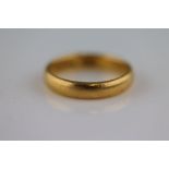 A 22ct yellow gold wedding band, width approximately 3.5mm, ring size N 1/2