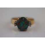 A black opal doublet and diamond 9ct yellow gold and white gold set ring, the central black opal