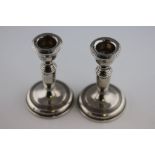 A pair of 20th century weighted silver dwarf candlesticks, slender baluster form, incised banding