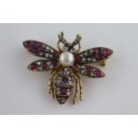 A pearl, ruby and diamond unmarked yellow gold doubled winged insect brooch, the thorax set with