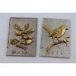 A pair of novelty silver Christmas cards, one with applied gilt robin perched on a branch,