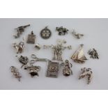 Seventeen assorted white metal charms to include telephone, sailing boat, a bunch of keys,