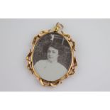 Late Victorian double photograph pendant contained within an ornate rose metal mount,