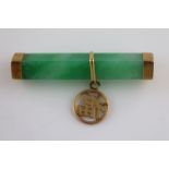 An early 20th century jade and unmarked gold Chinese bar brooch, the rectangular jade with yellow