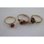 A garnet 9ct yellow gold cluster ring, rings size L together with two paste set yellow metal