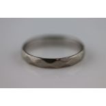 An 18ct white gold faceted wedding band, band width approximately 3mm, ring size M½