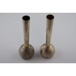 A pair of silver stem vases, bulb form, the circular textured bases with tapered smooth stems,