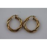 A pair of unmarked gold twisted hoop earrings, subtle tri-colour gold finish, diameter