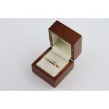 A diamond solitaire 18ct yellow gold ring, the claw set round brilliant cut champagne diamond stated