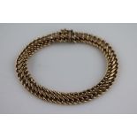 A 9ct yellow gold fancy figure of eight link bracelet, tongue and box snap clasp, length