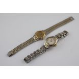 A ladies bi-tone stainless steel Gucci wristwatch, white dial, date aperture, gilt baton numerals