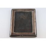 An early George V rectangular silver photograph frame, raised border, Birmingham 1912, W J Myatt &