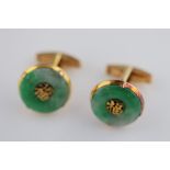 A pair of jade 14ct yellow gold cufflinks, the claw rub over set circular jade disc with centre gold