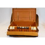 A 1930s Gents travel case containing initialled silver topped dressing table jars, London 1933,