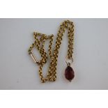 A 19th century foiled garnet unmarked rose gold pendant, the pear shaped faceted closed backed