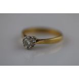 A diamond solitaire 18ct yellow gold and platinum set ring, the illusion set diamond weighing