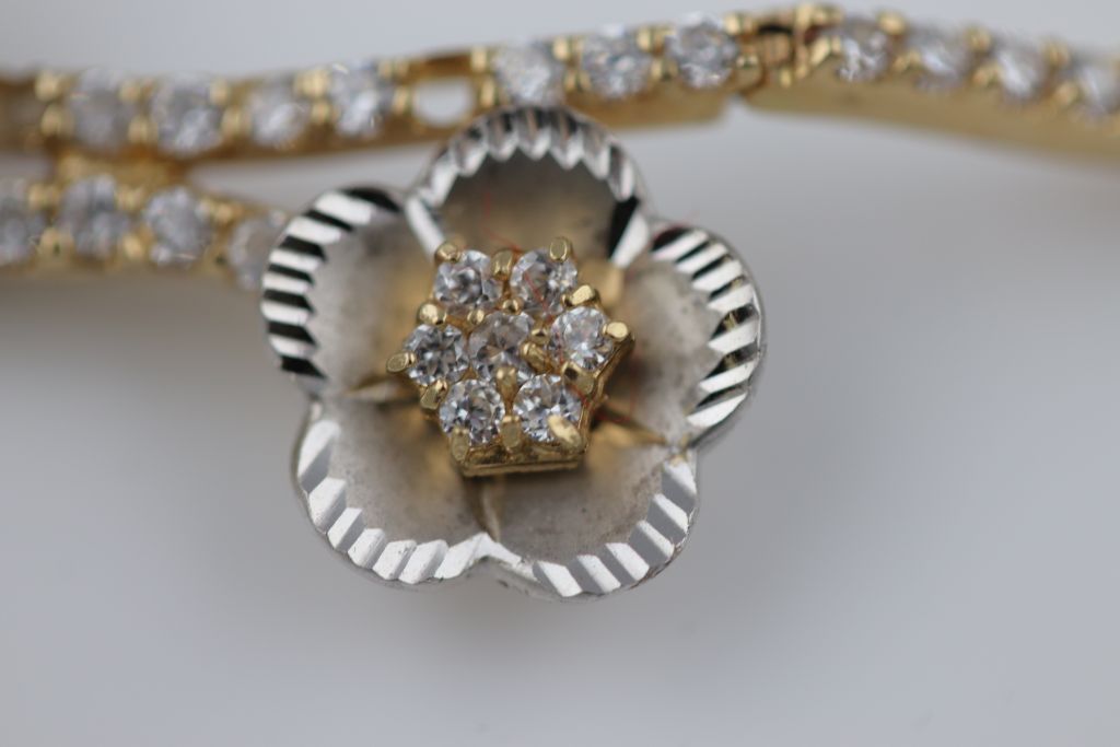 A white stone 14ct yellow and white gold bracelet, floral design, tongue and box snap clasp, - Image 5 of 5