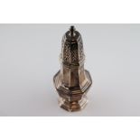 A George VI silver sugar caster of elongated octagonal baluster form, stepped foot, acorn finial,