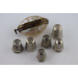 Two silver Charles Horner daisy pattern thimbles, Chester 1897 and 1914 sizes 9 and 6, together with