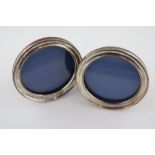 A pair of George V circular silver photograph frames, concave curved surround with incised border