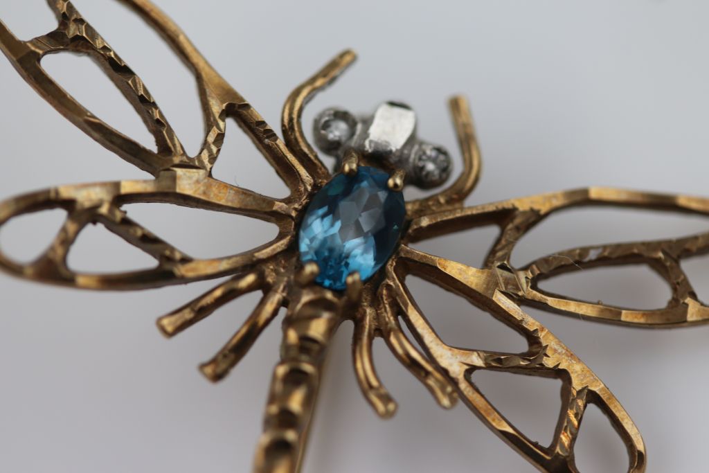 A blue topaz yellow metal dragonfly brooch, white stone eyes, approximately 32mm by 42mm, tests as - Image 7 of 7