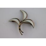 A Scandinavian style enamelled silver gilt vintage three leaf brooch, white enamelled leaves (some