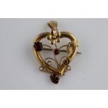 A late Victorian/Edwardian garnet 9ct yellow gold drop pendant brooch, the openwork heart shaped