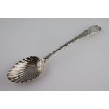 A George III silver serving spoon with fluted shell design bowl, twisted scroll engraved stem,