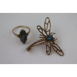 A blue topaz yellow metal dragonfly brooch, white stone eyes, approximately 32mm by 42mm, tests as