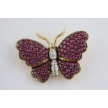 A ruby and diamond 18ct yellow gold butterfly brooch, wings outstretched, full set round mixed cut