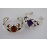 An amethyst silver bangle, the centre pear shaped cabochon cut amethyst measuring approximately 26mm