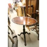 Georgian Mahogany Tilt Top Table, the oval top with piecrust edge raised on a turned support and