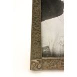 An early 20th Century Art nouveau Arts & Crafts pewter freestanding picture frame with image of