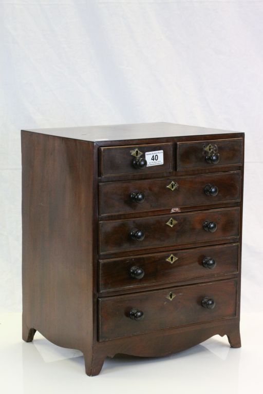 19th century Miniature mahogany apprentice chest of two over four drawers raised on bracket feet